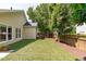 Lush backyard with artificial turf, a privacy fence, and mature trees at 105 Bridgegate Dr, Cary, NC 27519