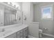 Bright bathroom with large mirror over the vanity and a window letting in natural light at 105 Bridgegate Dr, Cary, NC 27519