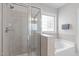 Bright bathroom featuring a glass shower and soaking tub at 105 Bridgegate Dr, Cary, NC 27519