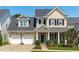 Charming two-story home featuring a two-car garage, well-manicured lawn and covered porch with white pillars at 105 Bridgegate Dr, Cary, NC 27519