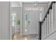 Bright and airy foyer with hardwood floors, staircase, and large windows providing natural light at 105 Bridgegate Dr, Cary, NC 27519