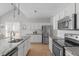 Spacious kitchen featuring white cabinets, stone countertops and stainless steel appliances at 105 Bridgegate Dr, Cary, NC 27519