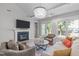 Cozy living room featuring a fireplace, hardwood floors and natural light at 105 Bridgegate Dr, Cary, NC 27519