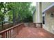 Wide shot of stained wood deck with stairs leading to the side yard of a yellow two-story house at 105 Old Dock Trl, Cary, NC 27519