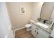Tastefully decorated powder room featuring a granite countertop, modern vanity, and wood-look floors at 105 Old Dock Trl, Cary, NC 27519