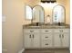 Modern bathroom with double vanity, granite countertops, and stylish mirrors at 105 Old Dock Trl, Cary, NC 27519