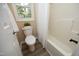 Cozy bathroom featuring a shower-tub combo and a window at 105 Old Dock Trl, Cary, NC 27519