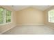 Bright bedroom with neutral carpet, large windows and vaulted ceiling at 105 Old Dock Trl, Cary, NC 27519
