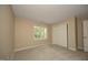 A vacant bedroom featuring neutral walls, carpeted floors, a window with natural light, and a closet at 105 Old Dock Trl, Cary, NC 27519