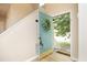 Inviting entryway with a vibrant blue door, adorned with a wreath, leading into a home with light wood floors at 105 Old Dock Trl, Cary, NC 27519