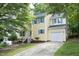 Charming two-story home with a well-maintained lawn and a paved driveway leading to a single-car garage at 105 Old Dock Trl, Cary, NC 27519