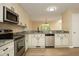 Updated kitchen featuring stainless steel appliances, granite countertops, and abundant storage at 105 Old Dock Trl, Cary, NC 27519