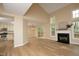 Spacious living room featuring hardwood floors, a cozy fireplace, and large windows offering ample natural light at 105 Old Dock Trl, Cary, NC 27519