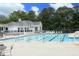 Community pool with multiple lanes and lounge chairs next to a white building at 105 Old Dock Trl, Cary, NC 27519