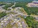 Extensive aerial view of neighborhood with homes, landscaping, and a pool at 109 Crested Coral Dr, Holly Springs, NC 27540