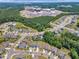 Expansive aerial shot of new neighborhood near a construction site and lush, green trees at 109 Crested Coral Dr, Holly Springs, NC 27540