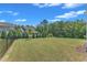 Spacious backyard featuring lush greenery and a view of neighboring homes at 109 Crested Coral Dr, Holly Springs, NC 27540