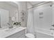 Clean bathroom featuring a single sink vanity and a shower-tub combo with white subway tile surround at 109 Crested Coral Dr, Holly Springs, NC 27540