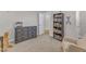 Bedroom featuring neutral walls, a wooden dresser, a bookshelf, and a comfortable rocking chair at 109 Crested Coral Dr, Holly Springs, NC 27540