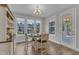 Charming dining area with a round table, four chairs, plenty of natural light, and an adjacent outdoor patio entrance at 109 Crested Coral Dr, Holly Springs, NC 27540