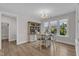 Bright dining area with natural light showcases a round table, comfortable seating, and a stylish hutch at 109 Crested Coral Dr, Holly Springs, NC 27540