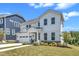 Charming two-story white home featuring a two-car garage, well-manicured lawn, and sidewalk leading to the front porch at 109 Crested Coral Dr, Holly Springs, NC 27540