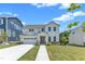 Charming two-story white home featuring a two-car garage and landscaped front yard at 109 Crested Coral Dr, Holly Springs, NC 27540