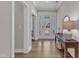 Welcoming foyer with hardwood floors, a glass-paneled front door, and a stylish console table with decor at 109 Crested Coral Dr, Holly Springs, NC 27540