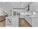 Gourmet kitchen with white cabinetry, stainless steel appliances and large center island at 109 Crested Coral Dr, Holly Springs, NC 27540
