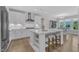 Eat-in kitchen with white cabinets, stainless steel appliances, and kitchen island at 109 Crested Coral Dr, Holly Springs, NC 27540