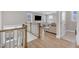 View from stairs of a modern living room with lots of natural light at 109 Crested Coral Dr, Holly Springs, NC 27540