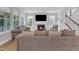 Cozy living room boasts a fireplace, TV, and multiple windows providing lots of natural light at 109 Crested Coral Dr, Holly Springs, NC 27540