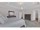 Bright main bedroom with a king bed, tray ceiling, and carpeted floor at 109 Crested Coral Dr, Holly Springs, NC 27540