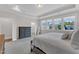 Charming main bedroom with large windows, natural light, carpeted floor, and a tray ceiling at 109 Crested Coral Dr, Holly Springs, NC 27540
