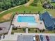 Aerial view of a pristine community pool featuring lounge chairs and a clean pool house at 109 Crested Coral Dr, Holly Springs, NC 27540