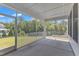 Relaxing screened-in porch with views of the beautiful, wooded backyard at 109 Crested Coral Dr, Holly Springs, NC 27540