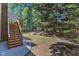 Backyard with deck stairs, walkway, and small bridge, framed by mature trees at 111 Ferncroft Ct, Cary, NC 27519