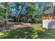 Backyard with bridge, lush lawn, and mature trees creating a private oasis at 111 Ferncroft Ct, Cary, NC 27519