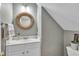 Cozy bathroom features gray walls, a woven-framed mirror, and white vanity at 111 Ferncroft Ct, Cary, NC 27519
