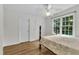 Bedroom with hardwood floors, a ceiling fan, and a double window for natural light at 111 Ferncroft Ct, Cary, NC 27519