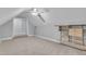 Finished attic bedroom with built-in shelves, carpet floors, and dormer window at 111 Ferncroft Ct, Cary, NC 27519