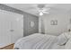 Bedroom with hardwood floors, wallpaper accent wall, and double door closets at 111 Ferncroft Ct, Cary, NC 27519