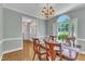 Inviting dining room boasts wood floors, large window and elegant chandelier at 111 Ferncroft Ct, Cary, NC 27519