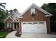 Charming brick home featuring a two-car garage and flower boxes under the windows at 111 Ferncroft Ct, Cary, NC 27519
