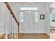 Inviting foyer featuring a white front door, oak floors and windowed transom at 111 Ferncroft Ct, Cary, NC 27519