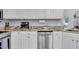 Updated kitchen features stainless dishwasher, granite counters, and white cabinets at 111 Ferncroft Ct, Cary, NC 27519