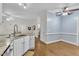 Updated kitchen features white cabinets and hardwood floors and open floor plan at 111 Ferncroft Ct, Cary, NC 27519