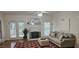 Living room featuring a brick fireplace, large windows and hardwood floors at 111 Ferncroft Ct, Cary, NC 27519