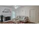 Comfortable living room with a decorative fireplace, hardwood floors and a ceiling fan at 111 Ferncroft Ct, Cary, NC 27519