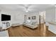 Cozy living room with hardwood floors, a ceiling fan, and neutral-toned furnishings at 111 Ferncroft Ct, Cary, NC 27519